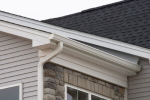 White rain gutters on a home with asphalt roof